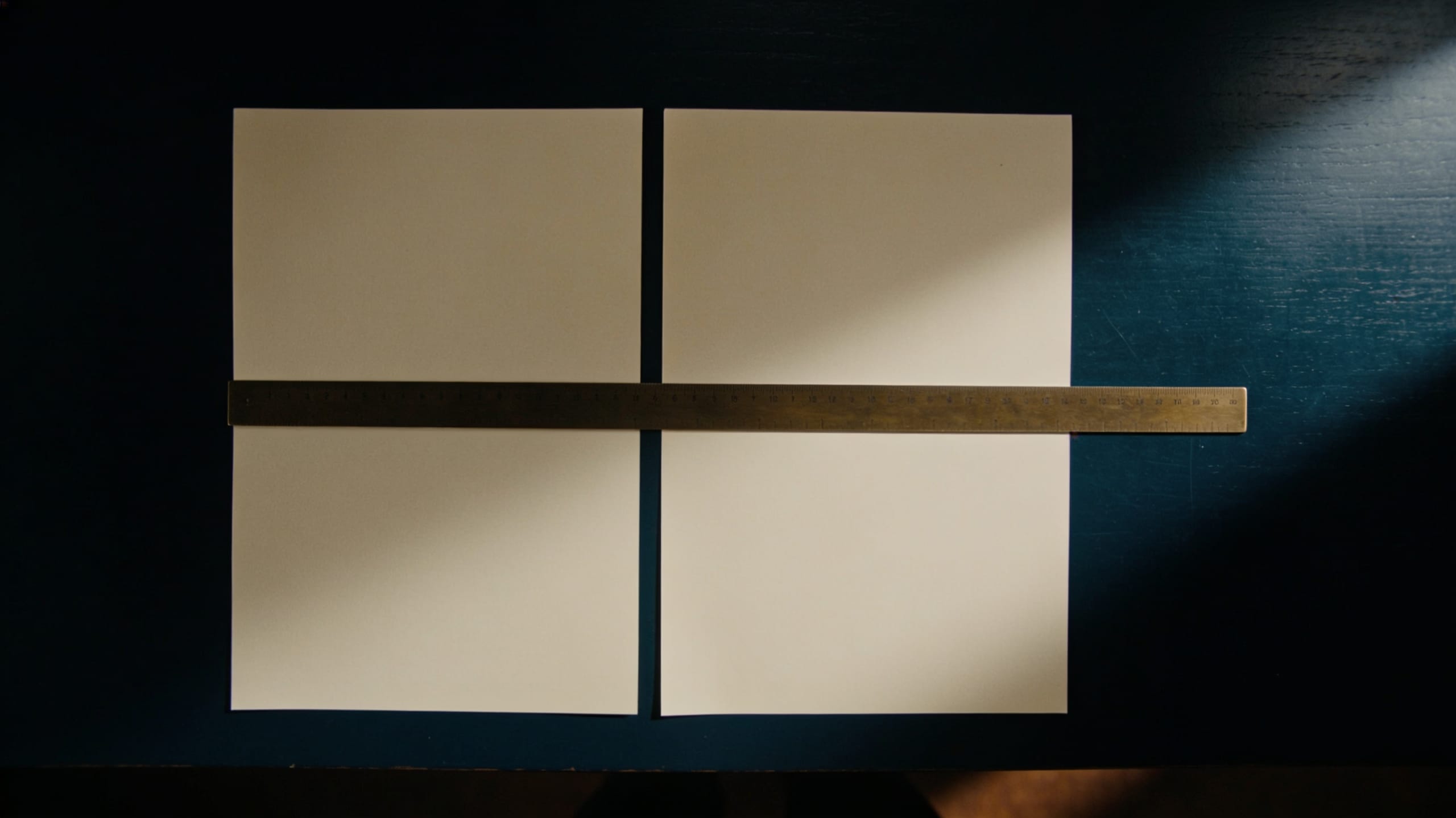 Two blank sheets side by side joined by a brass rule